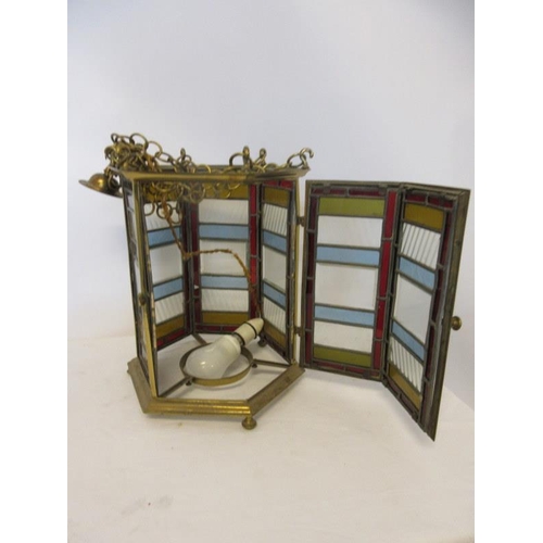 102 - A good antique brass framed hall lantern with coloured and clear glass panels. H. 36cm approx.