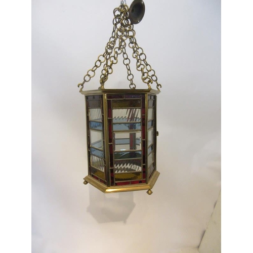 102 - A good antique brass framed hall lantern with coloured and clear glass panels. H. 36cm approx.