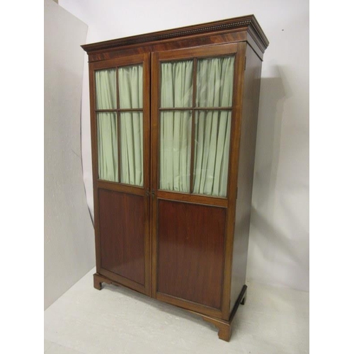 116 - Antique mahogany wardrobe having a dental cornice over sectioned glass and panelled doors and raised... 