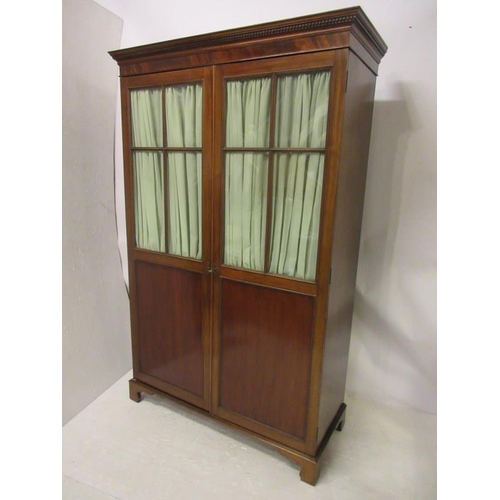 116 - Antique mahogany wardrobe having a dental cornice over sectioned glass and panelled doors and raised... 