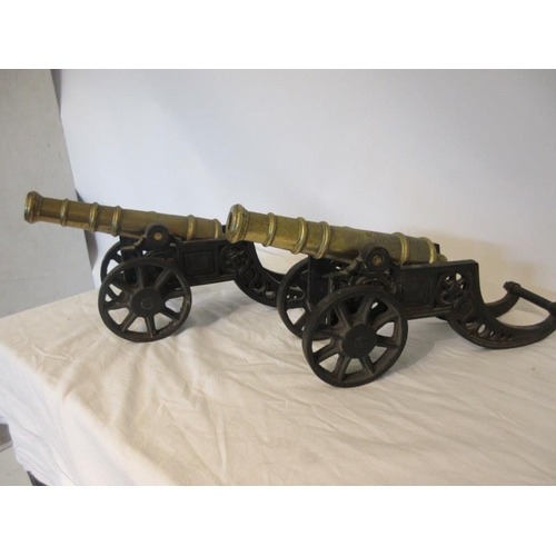 118 - Pair of antique brass signal cannons on metal carriages.