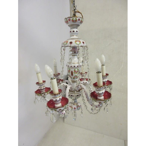 121 - A decorative red glass overlay six branch chandelier.
(Buyer has option on following lot.)