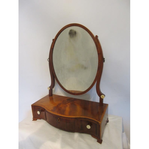 124 - Antique mahogany serpentine shaped dressing mirror having rosewood banding and fitted with three dra... 