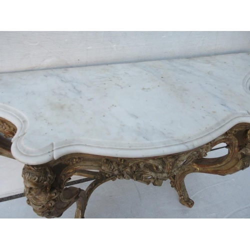 126 - A fine antique serpentine shaped console table decorated with carved heads and raised on cabriole le... 