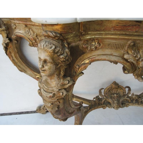 126 - A fine antique serpentine shaped console table decorated with carved heads and raised on cabriole le... 