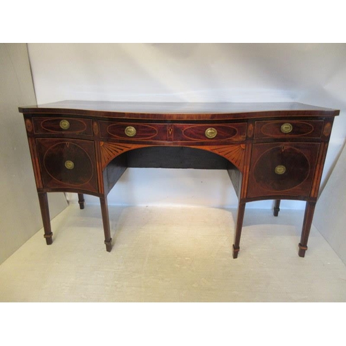 135 - A fine Irish Georgian sideboard, the serpentine shaped top having inlaid oval panels, the freize fit... 