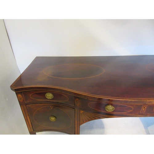 135 - A fine Irish Georgian sideboard, the serpentine shaped top having inlaid oval panels, the freize fit... 