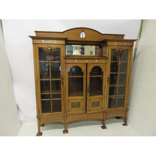 150 - A late 19th century Arts & crafts oak side cabinet having mother of pearl inlay, the side doors with... 