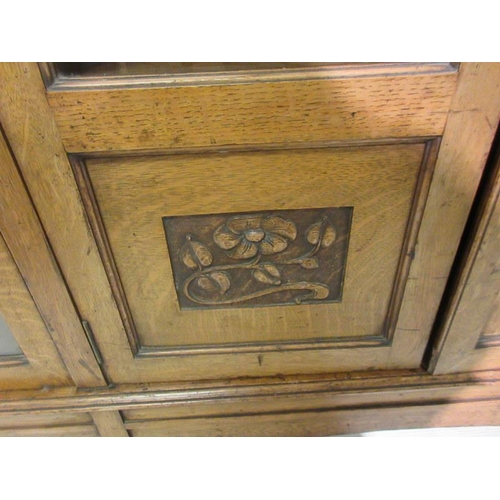 150 - A late 19th century Arts & crafts oak side cabinet having mother of pearl inlay, the side doors with... 