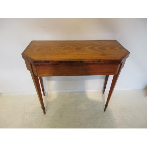 153 - A Georgian satinwood & rosewood crossbanded card table having inlaid freize and raised on square tap... 