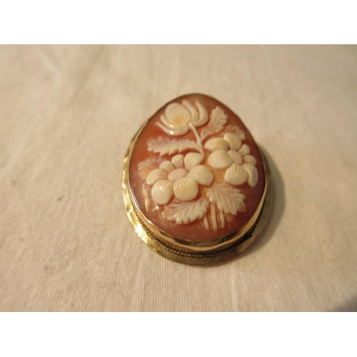 191 - Gold cased cameo style brooch with raised flower decoration.