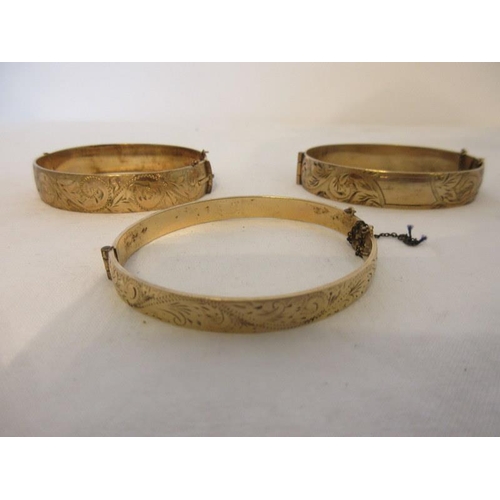 195 - Three bangles 9ct rolled gold and two chains.