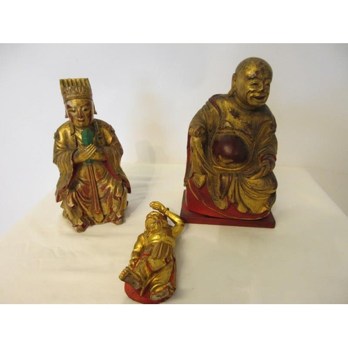 244 - A group of Chinese carved gilt wood statues. (3)