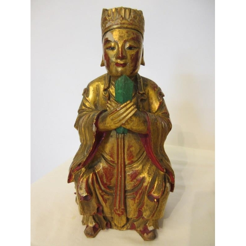 244 - A group of Chinese carved gilt wood statues. (3)