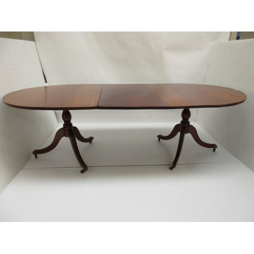 61 - A Regency style mahogany twin pod dining table with spare leaf probably O'Connell's Cork.