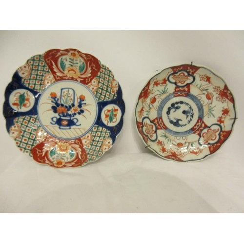 66 - Two antique Imari circular wall plaques.