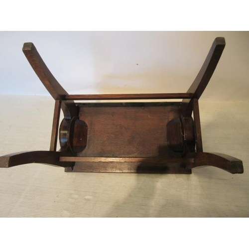 74 - An 19th century oak and brass decorated hall stool raised on four sabre legs with cross stretchers. ... 