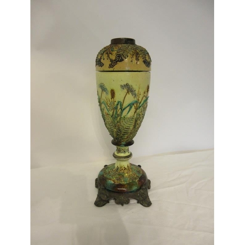 99 - A Victorian majolica oil lamp on metal base.