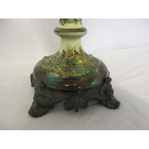 99 - A Victorian majolica oil lamp on metal base.