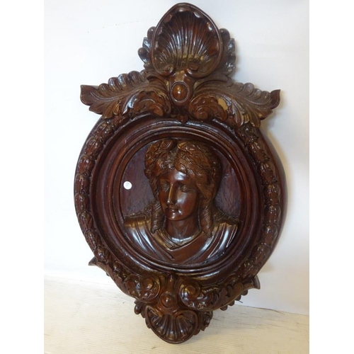 35 - Decorative timber wall plaque with carved head and shell decoration.  Length 80cm approx.