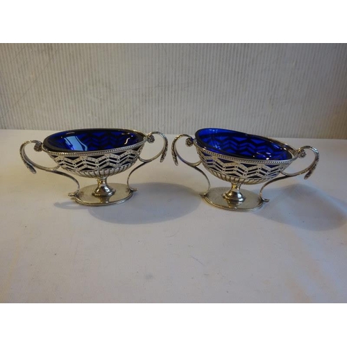 430 - A pair of silver Adams design mustard pots with blue glass liners. London 1781. 8 troy ozs.