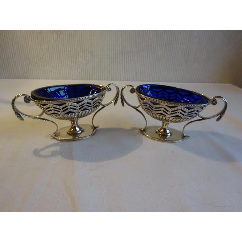 430 - A pair of silver Adams design mustard pots with blue glass liners. London 1781. 8 troy ozs.