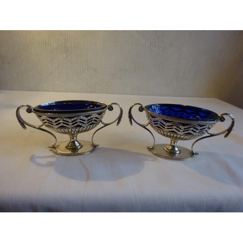 430 - A pair of silver Adams design mustard pots with blue glass liners. London 1781. 8 troy ozs.