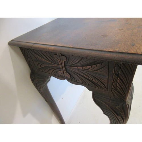 57 - Neat sized antique oak table having carved freize and sides and raised on four pad feet. W. 73cm, D.... 