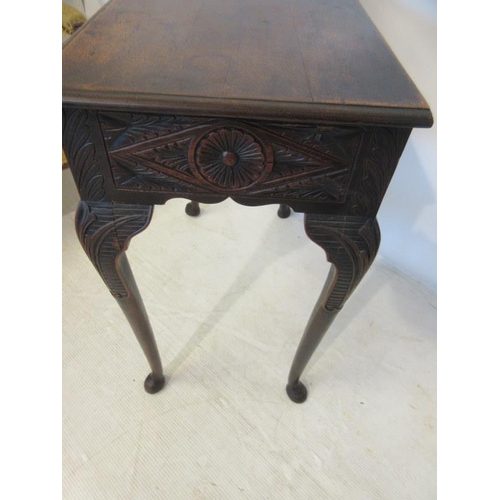 57 - Neat sized antique oak table having carved freize and sides and raised on four pad feet. W. 73cm, D.... 