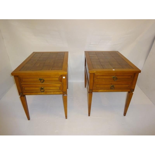 125 - A pair of American lamp tables raised on tapered legs.  D. 72cm  W. 50cm  H. 64cm approx.