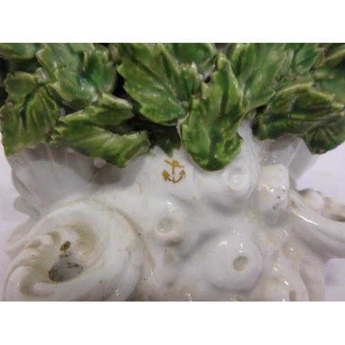 132 - A pair of flower encrusted porcelain figures.