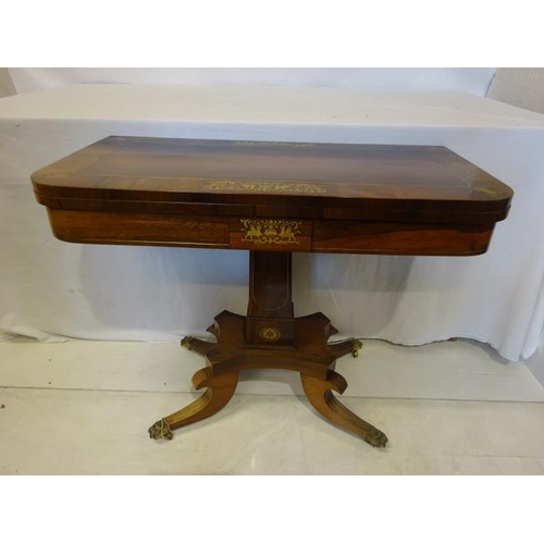 153 - A rosewood and brass inlaid fold over card table raised on centre column platform base on four splay... 