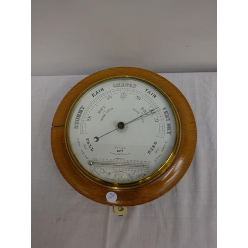 173 - Late Victorian oak cased circular barometer and therometer. Diameter 29cm.