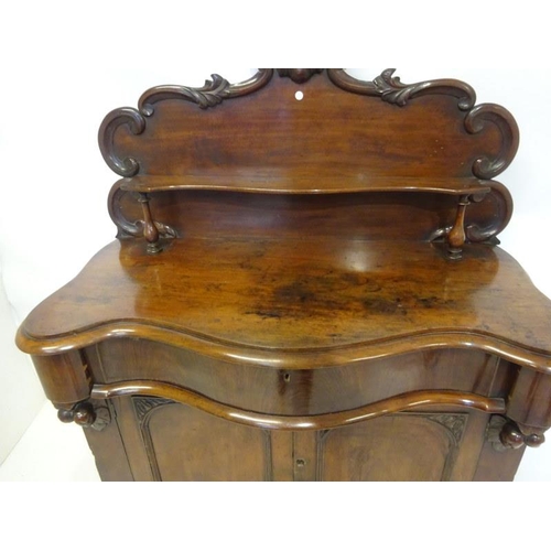 194 - Victorian mahogany side cabinet having carved back with shelf, serpentine shaped drawer over two doo... 