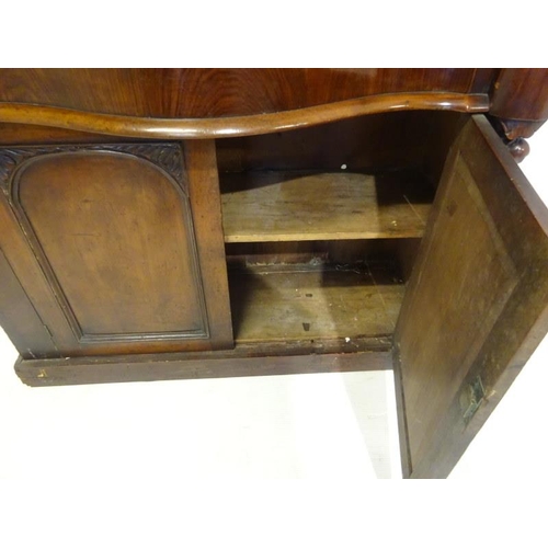 194 - Victorian mahogany side cabinet having carved back with shelf, serpentine shaped drawer over two doo... 