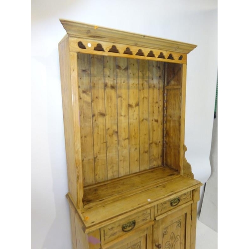 217 - Old pine dresser having shelved upper section, the base fitted with two drawers and two cupboard doo... 