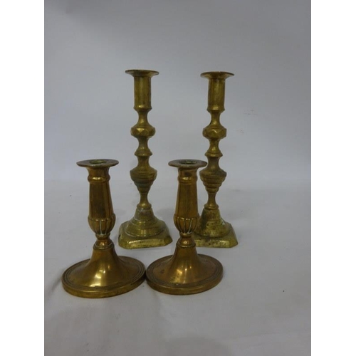 238 - Two pairs of brass candlesticks.