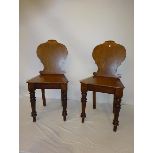 42 - A pair of Victorian mahogany hall chairs.
