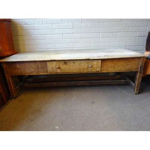 48 - Large antique pine laundry table fitted with a centre drawer and having twin cross stretchers. 255cm... 