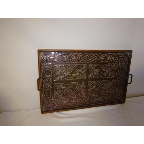 52 - A Celtic design copper framed plaque in the form of a tray. 54cm x 34cm approx.