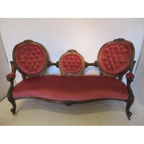 60 - A Victorian walnut framed drawing room couch, the back having three oval shaped panels over serpenti... 