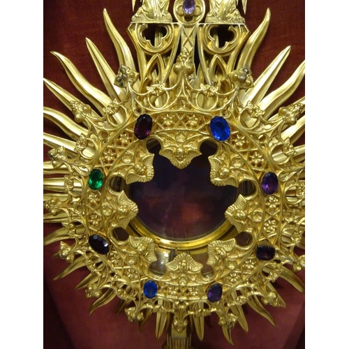 63 - A gilded Monstrance with carrying case and a brass shaped crown. (2)