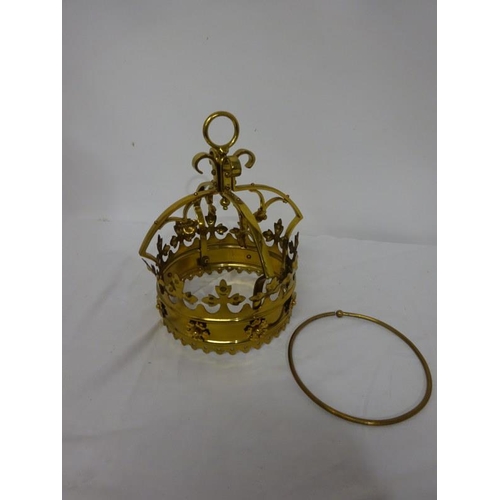 63 - A gilded Monstrance with carrying case and a brass shaped crown. (2)