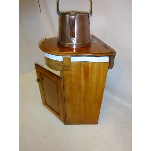 70 - A Victorian ship's washstand, the mahogany case having a shaped top and fitted with a china washbasi... 