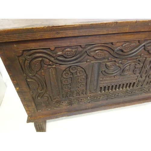 75 - A large antique oak coffer, the front panel extensively carved and dated 1902 more likely made for t... 