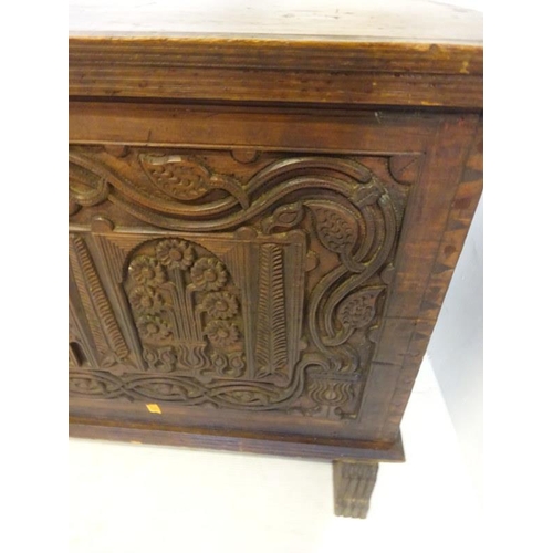 75 - A large antique oak coffer, the front panel extensively carved and dated 1902 more likely made for t... 