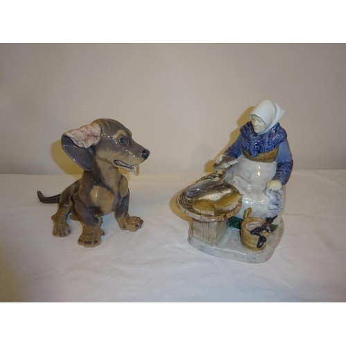 79 - Royal Copenhagen - A Danish porcelain figure of a seated fish seller with fish and scales together w... 