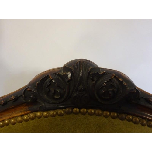 80 - A pair of antique French carved rosewood drawing room easy chairs having open arms and raised on cab... 