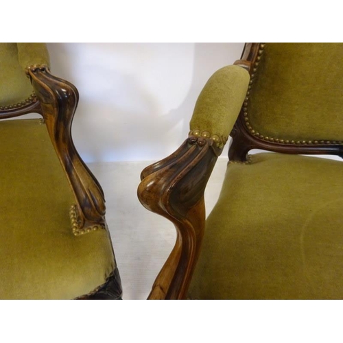 80 - A pair of antique French carved rosewood drawing room easy chairs having open arms and raised on cab... 