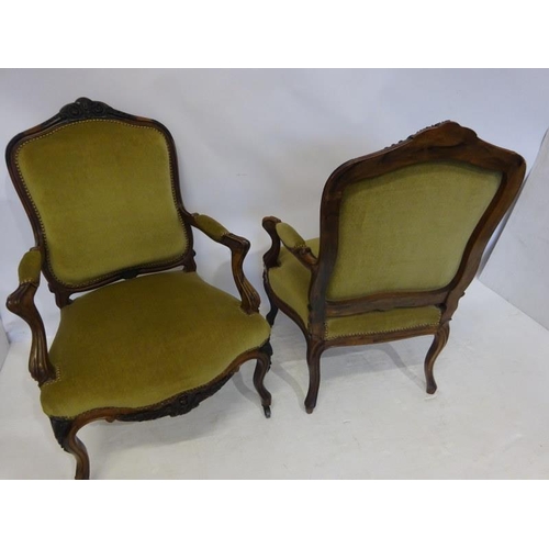 80 - A pair of antique French carved rosewood drawing room easy chairs having open arms and raised on cab... 